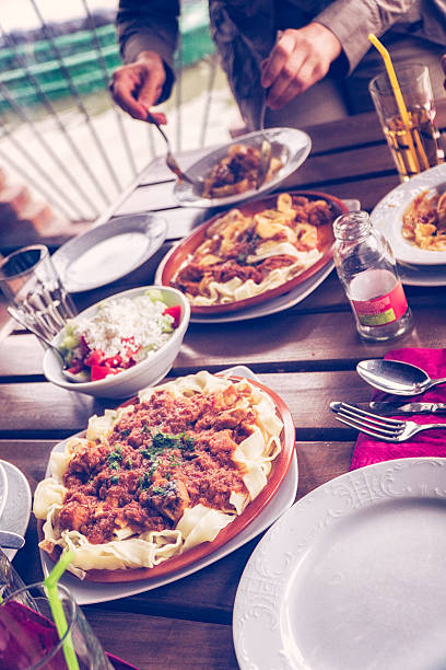 istock Eating Parpadelle with Goulash and Fresh Salad 604345152