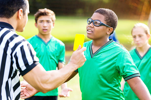 coach talking to the teenage boys athletes