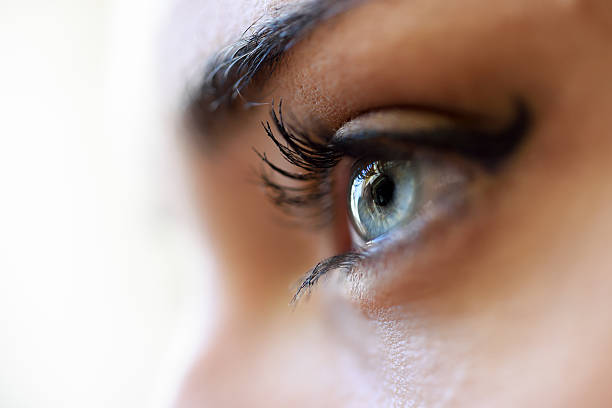 istock Close-up of young woman's blue eyes with long eyelashes 604347962