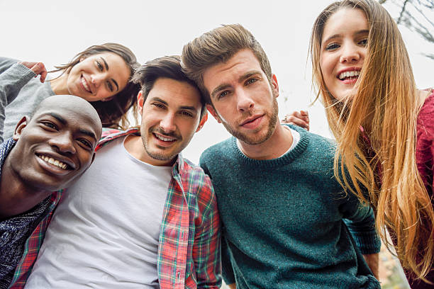 istock Multiracial group of friends taking selfie 604348458