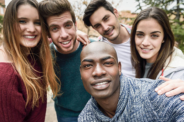 istock Multiracial group of friends taking selfie 604348716