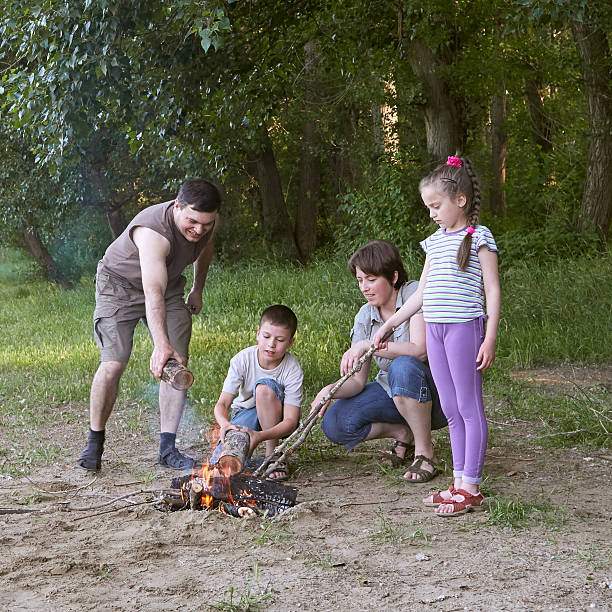 istock people camping in forest, family active in nature, kindle fire 604349182