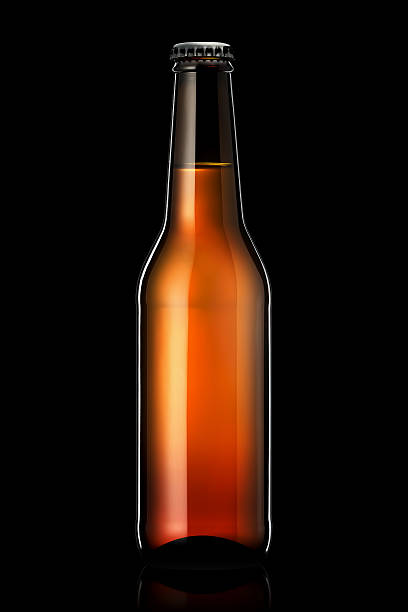 istock Bottle of beer or cider isolated on black background 604351530