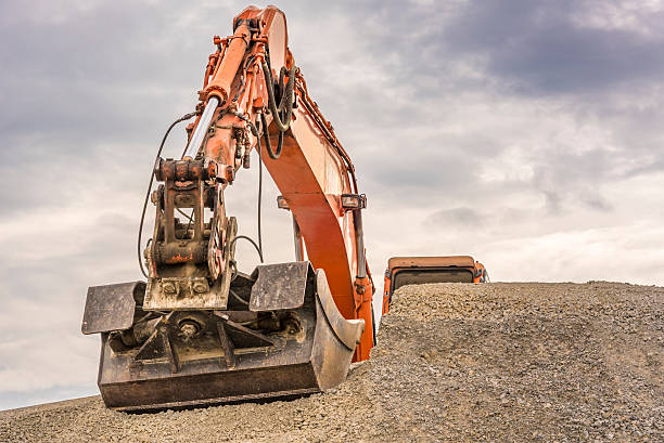 istock Orange excavator arm and bucket details 604353266