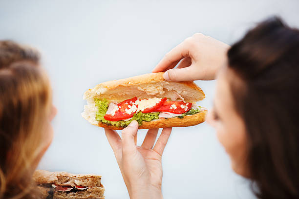 istock Girls Eating Sandwiches 604354572