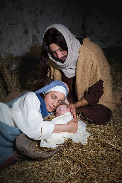 istock Kneeling parents in nativity scene 604354956
