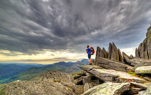 Explorer Glyder fach An explorer explores the Gylder Fach high up on Snowdonia moutain range in Wales. Emphasising exploration and traveling, backpacking and hiking in the outdoor world. snowdonia stock pictures, royalty-free photos & images