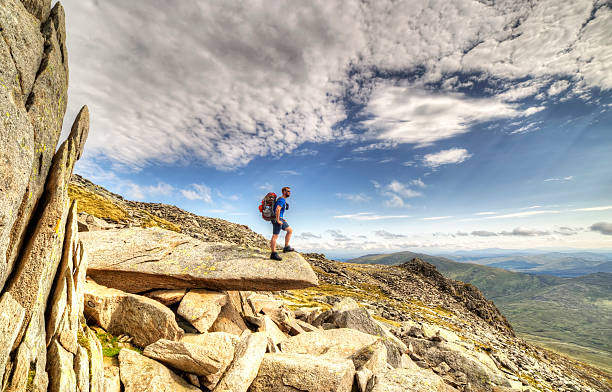 Explorer Glyder fach An explorer explores the Gylder Fach high up on Snowdonia moutain range in Wales. Emphasising exploration and traveling, backpacking and hiking in the outdoor world. mount snowdon photos stock pictures, royalty-free photos & images