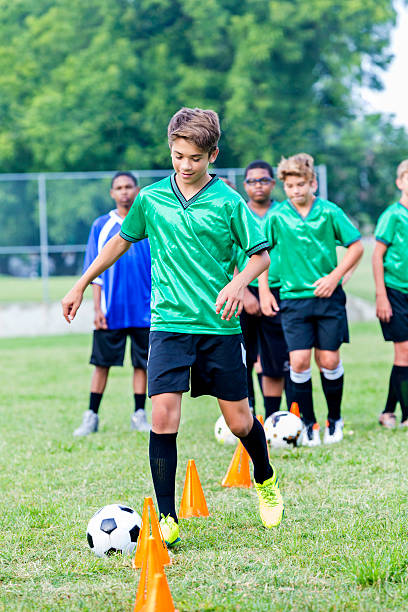 istock Confident Hispanic teenage soccer player at soccer practice 604355496