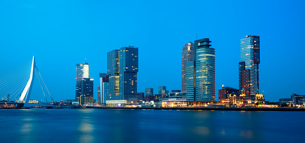Panoramic view of Rotterdam skyline illuminated at dusk, Netherlands, Benelux, Europe, long exposure with tripod, panoramic image created from 8 long exposures, 50 megapixel image.