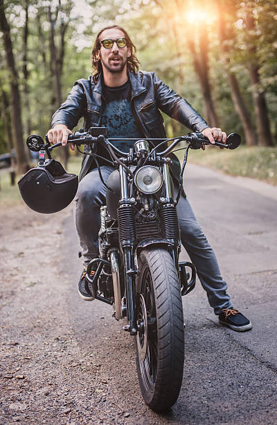 istock Biker man sitting on his motorcycle 604357060