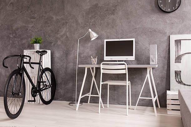 istock Black bicycle in grey and white living room 604357086