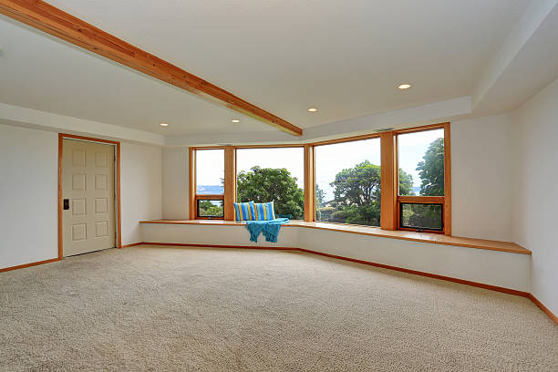 istock Empty room interior with carpet floor and large sitting area 604357120