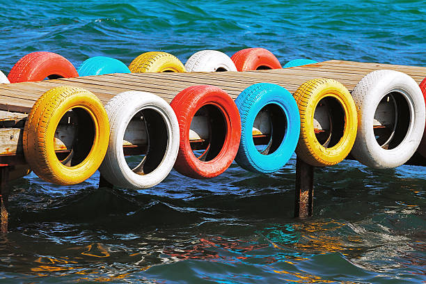 Color tires from cars on the wooden sea bridge