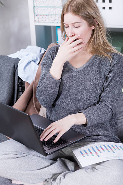istock Sleepy and yawning but still doing her job 604358044