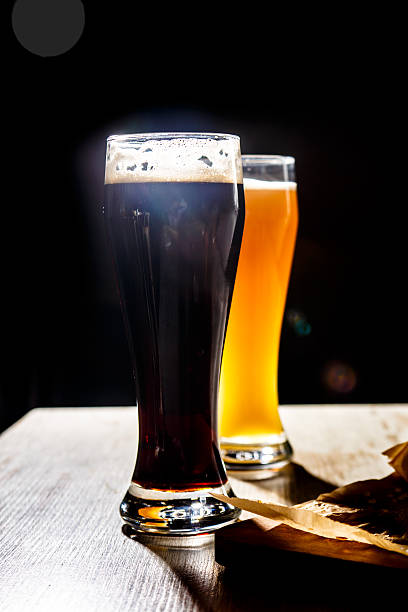 istock Two glasses of beer standing on the table 604358624