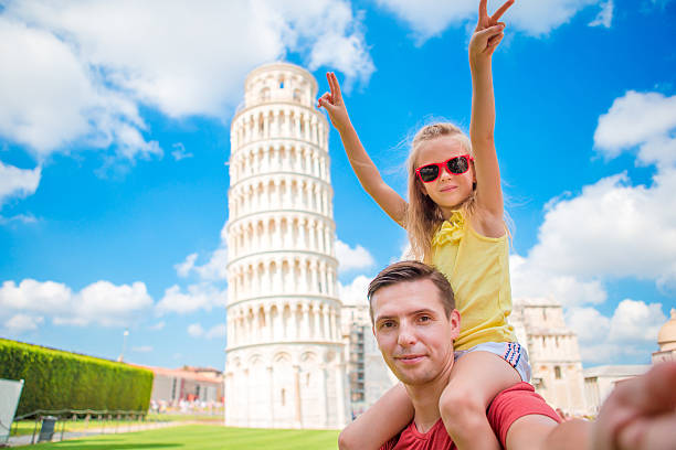 istock Family portrait background the Learning Tower in Pisa. Pisa - 604360162