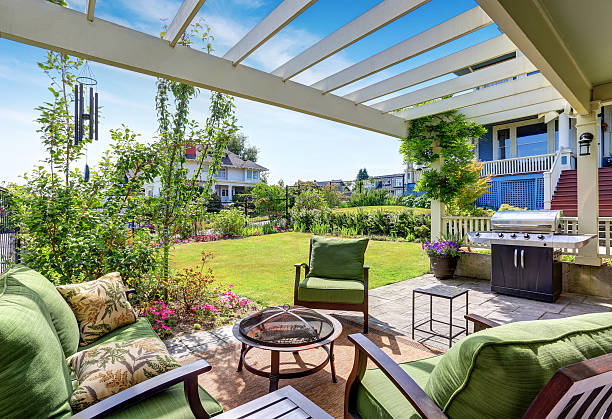 istock Covered patio area with outside chairs in the backyard garden. 604361172