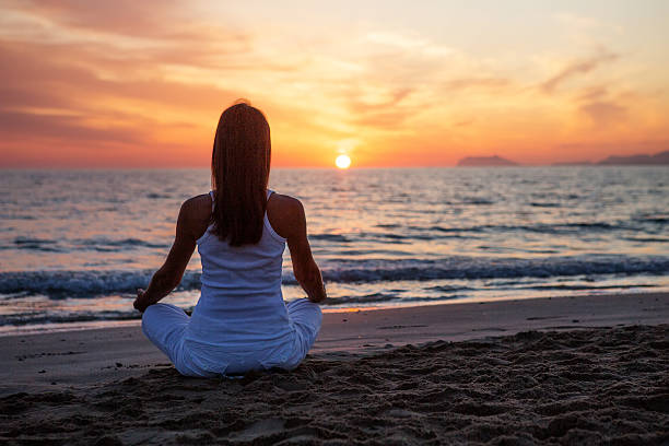 istock Caucasian woman practicing yoga at seashore 604361228