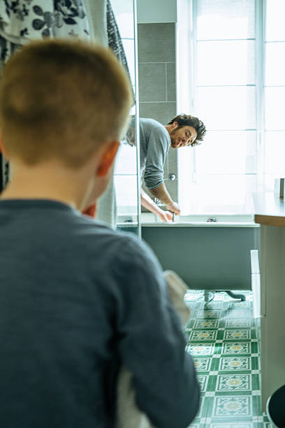 istock Father preparing the bathtub for his son 604361470