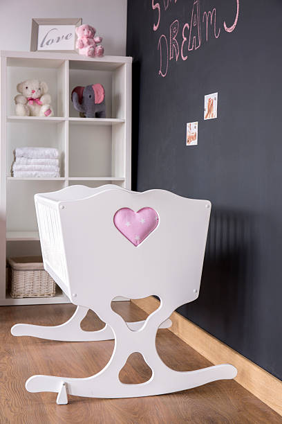 istock Cute white cradle in nursery room 604361940
