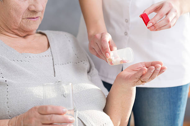 istock Woman giving medicine 604362596