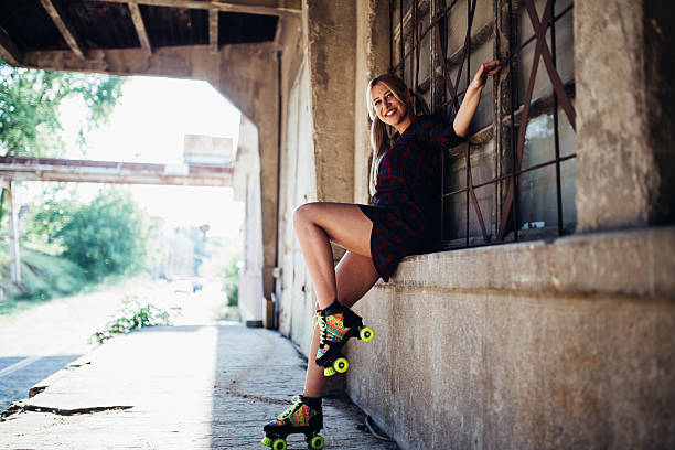 istock Girl sitting with roller skates 604365476