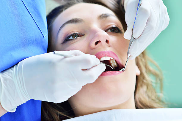 istock Woman lying in the dentist's chair having a checkup 604366170