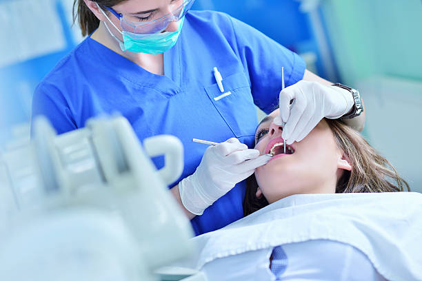 istock Woman lying in the dentist's chair having a checkup 604366198