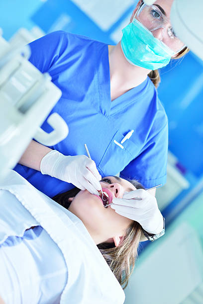 istock Woman lying in the dentist's chair having a checkup 604366250