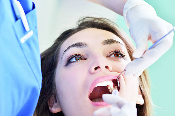istock Woman lying in the dentist's chair having a checkup 604366510