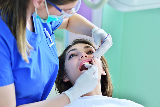 istock Woman lying in the dentist's chair having a checkup 604366528
