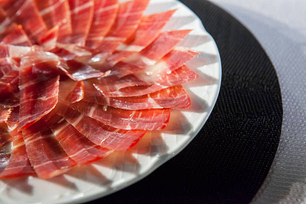 istock Decorative arrangement of iberian cured ham on plate 604366702
