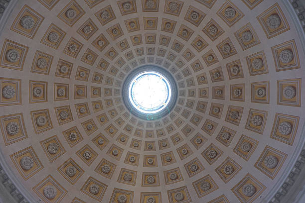 Rome, Italy, march 2017: The Pantheon  is a former Roman temple, now a church, in Rome. The building is circular with a portico of large granite Corinthian columns under a pediment. A rectangular vestibule links the porch to the rotunda, which is under a coffered concrete dome, with a central opening (oculus) to the sky. Almost two thousand years after it was built, the Pantheon's dome is still the world's largest unreinforced concrete dome. The height to the oculus and the diameter of the interior circle are the same, 142 feet