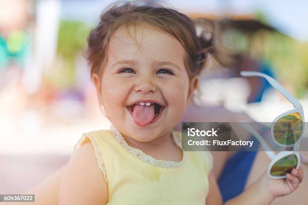 Portrait Of Baby Girl With Sunglasses On A Beach Stock Photo - Download Image Now - Baby - Human Age, Child, Smiling