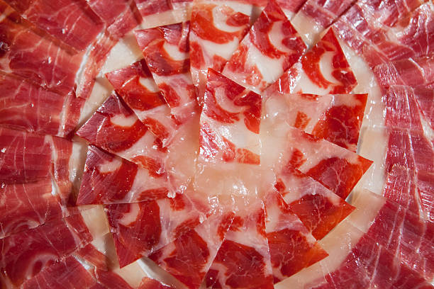 istock Circular decorative arrangement of iberian cured ham on plate 604367174