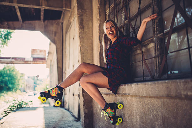 istock Girl sitting with roller skates 604367540