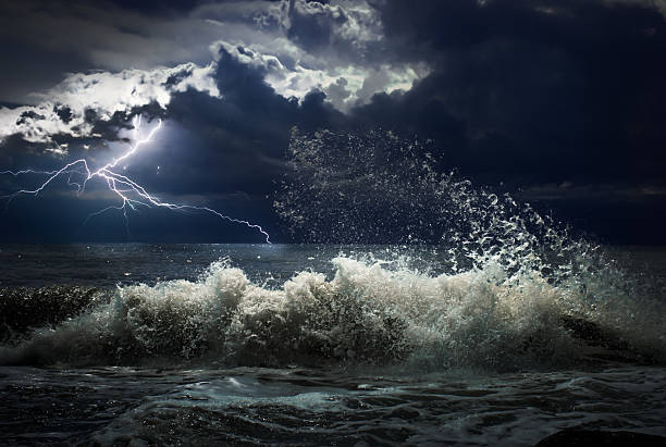 istock dark ocean storm with lgihting and waves at night 604367750