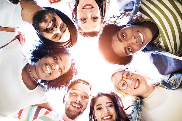 istock Friends Huddle Join Holiday Party Group Concept 604368068