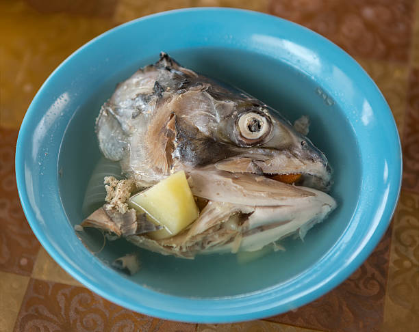 istock Ear in a plate with head of red fish. 604371408
