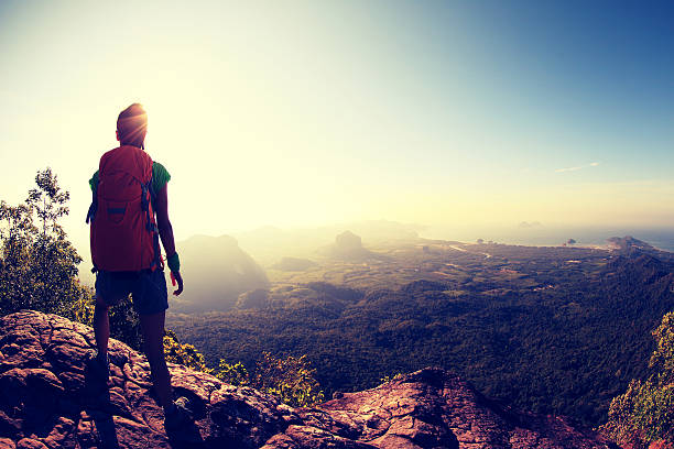 istock young woman backpacker hiking on mountain peak cliff 604374534