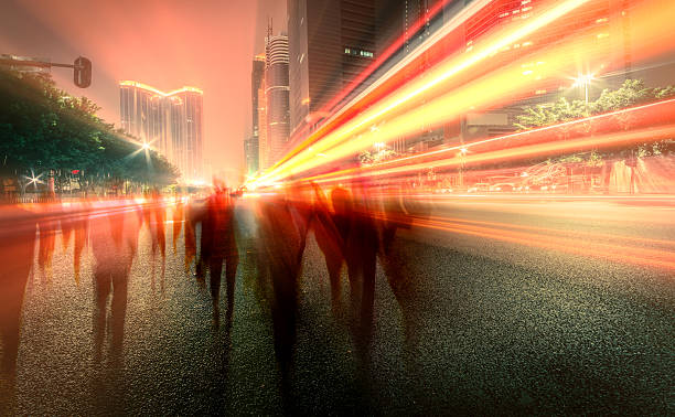 istock blur people and traffic on a street at night 604376578