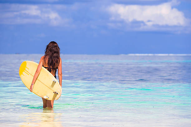 istock Young surfer woman surfing during beach vacation 604376648