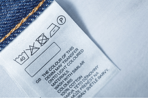 Clothing label with laundry care instruction, close up
