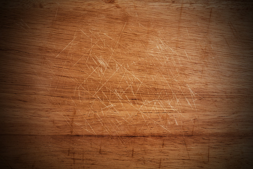 Old scratched wooden cutting board texture