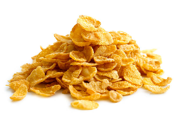 istock Heap of cornflakes isolated on white. 604381572
