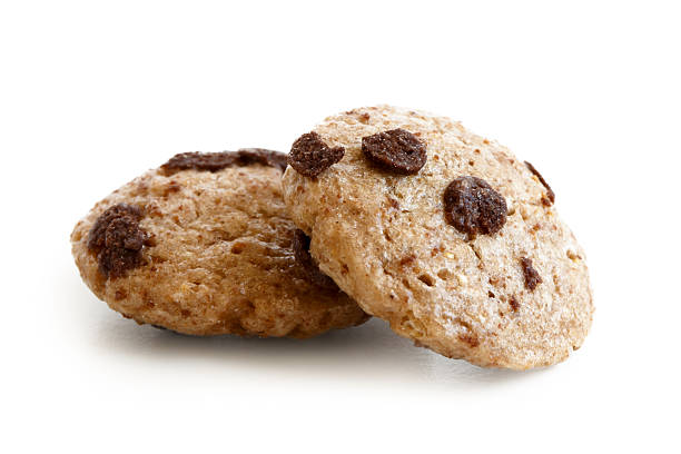 istock Two chocolate chip cookies cereal isolated on white. 604381826