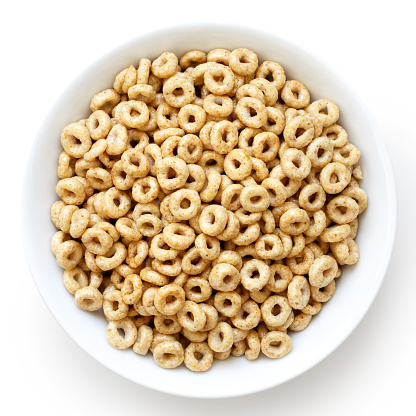 Bowl of honey cheerios isolated on white from above.