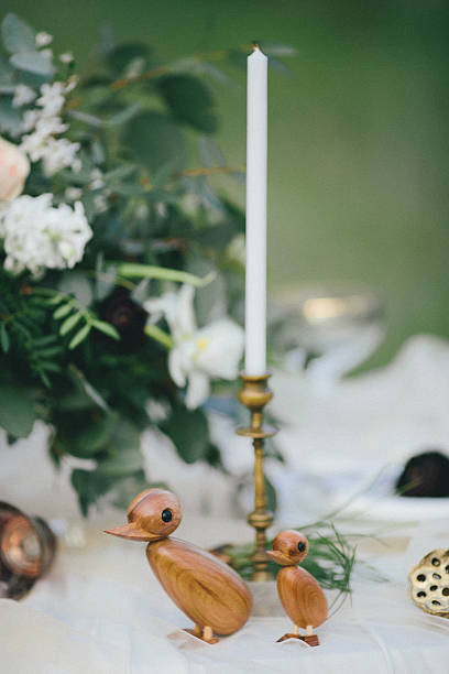istock Figurines of wooden ducks on a table 604382482