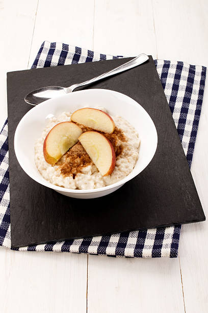 istock with milk boiled porridge, apple pieces, cinnamon and sugar 604382960